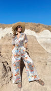 Elegant resort outfit styled with a wide sunhat in desert setting