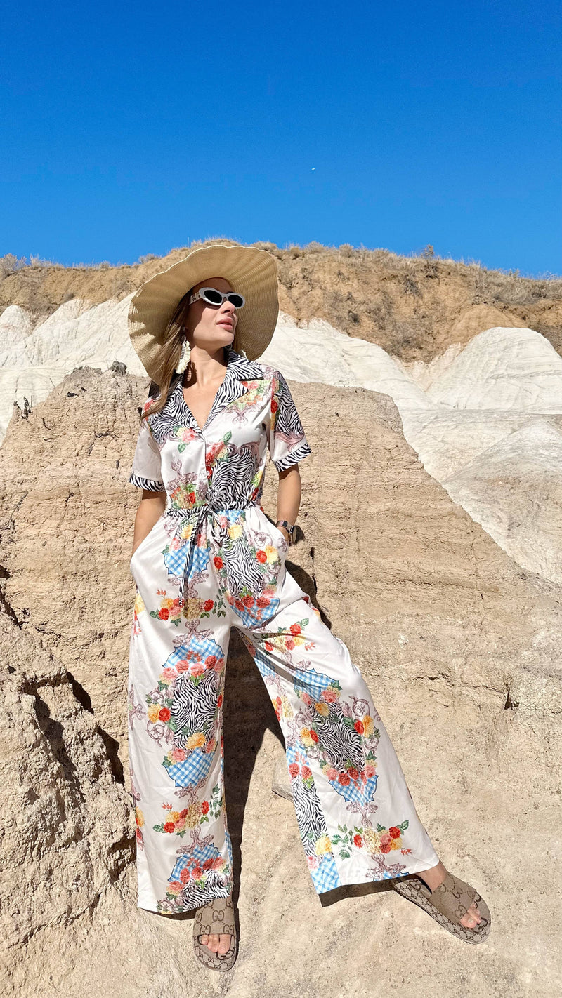 Elegant resort outfit styled with a wide sunhat in desert setting