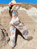 Woman wearing vacation co-ord with animal and gingham patterns