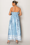 Model wearing pastel blue vacation dress with delicate flower print