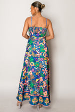Model wearing bold tropical print vacation dress in blue tones