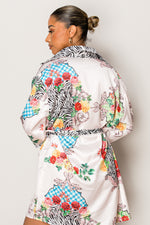 Model in short belted vacation dress with patchwork-style print

