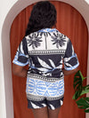 Model wearing bold geometric print co-ord in black, white, and light blue.