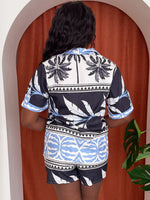 Model wearing bold geometric print co-ord in black, white, and light blue.