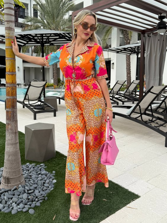 Bold resort jumpsuit in pink, orange, and leopard print