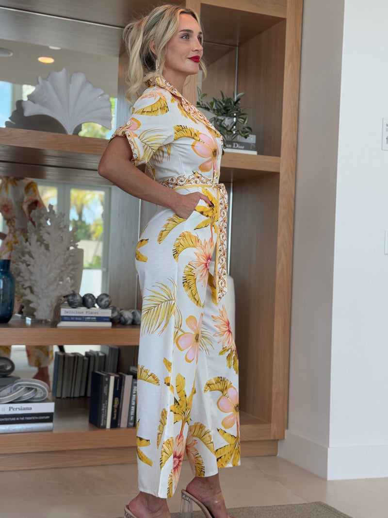 Short-sleeve collared jumpsuit in golden floral print with sash belt.