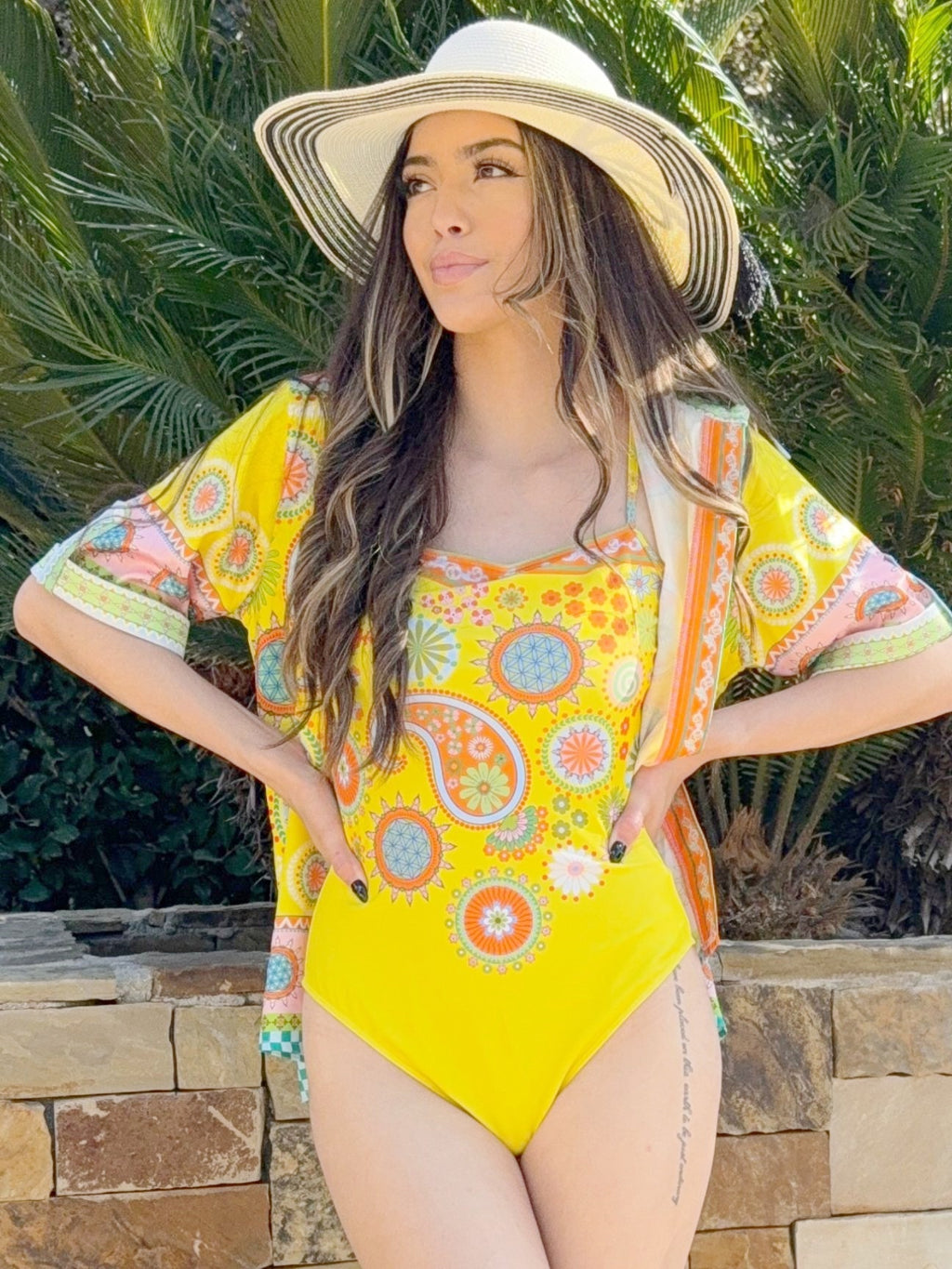 Woman in yellow printed one-piece swimsuit with matching cover-up