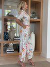 Elegant resort jumpsuit featuring multicolor botanical illustrations.