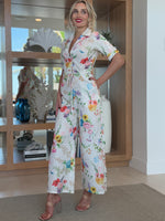 Lightweight white jumpsuit with colorful florals and relaxed fit.