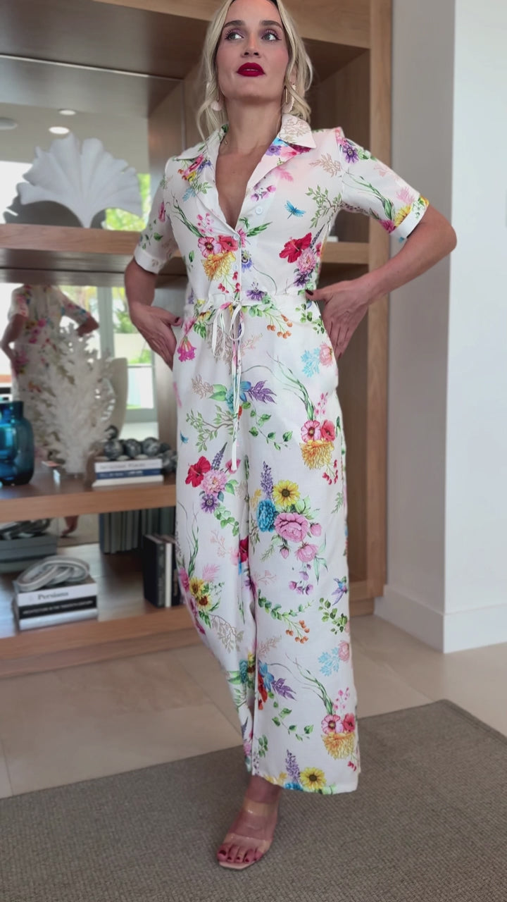 Feminine floral printed jumpsuit styled with clear heels and red lipstick.