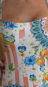 Resort swimwear with orange stripes and Mediterranean print