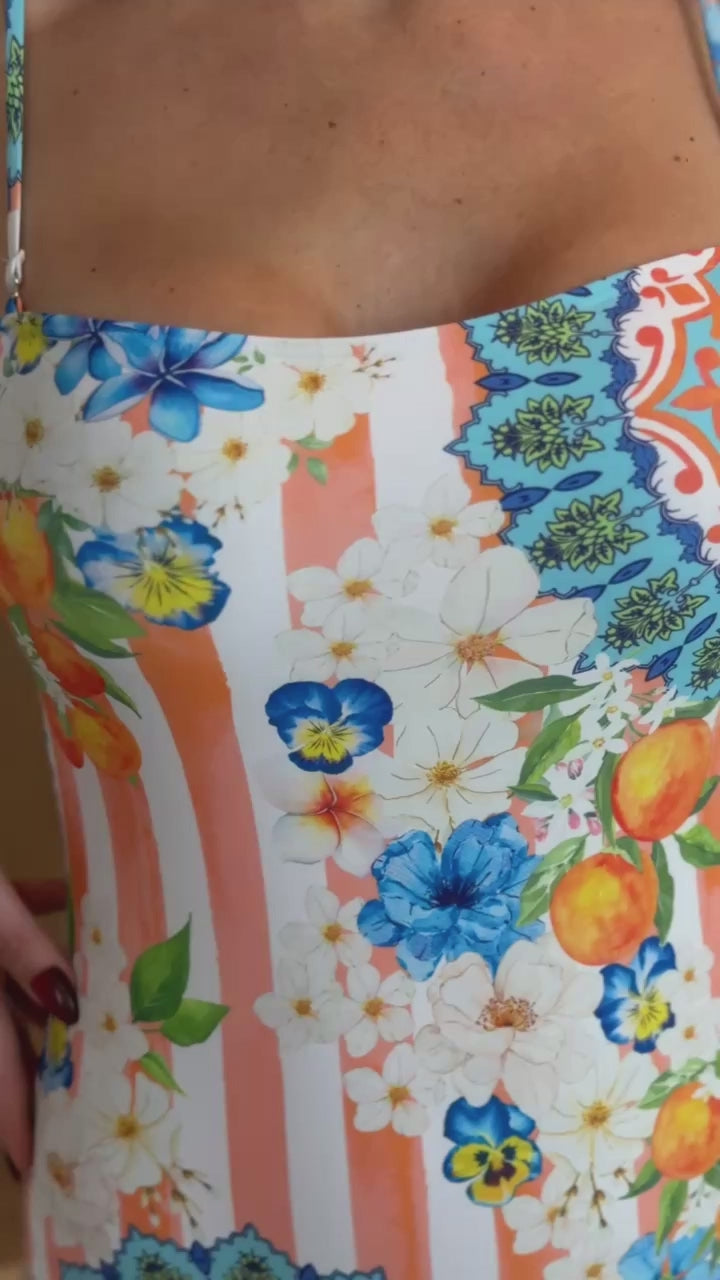 Resort swimwear with orange stripes and Mediterranean print