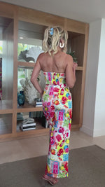Resort-ready jumpsuit with rainbow market illustrations and relaxed fit.